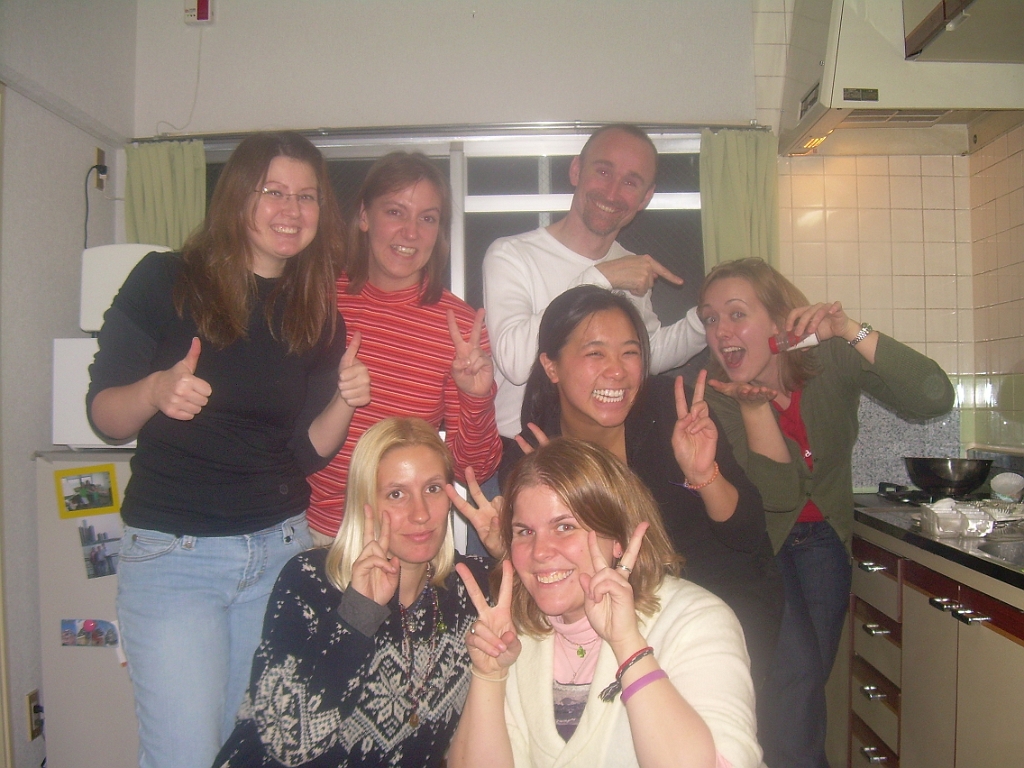 dscn0890.jpg - Fast forward to Thanksgiving Day, where the Americans (and one Australian) have gathered at my apartment for the best Thanksgiving dinner we could put together in Japan. Pictured are Katie J, me, Andrew, Myra, Katie P, and in front, Jamie and Renee.