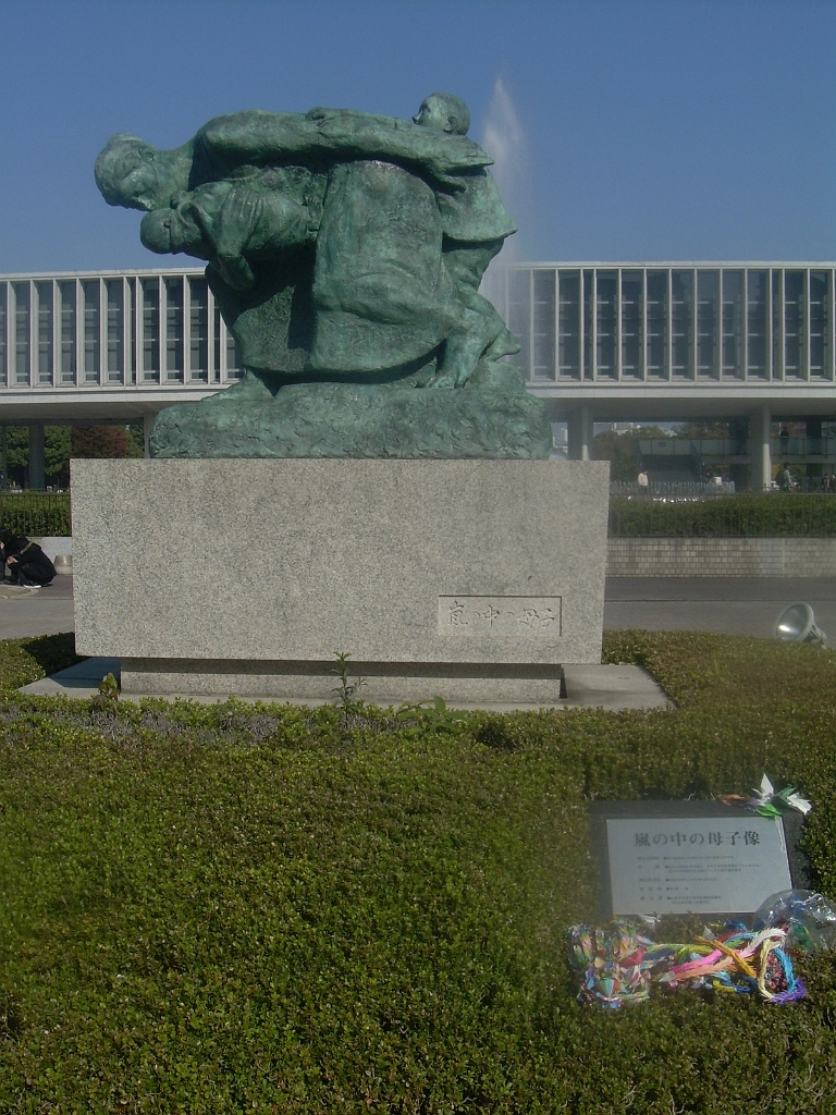 dscn0947.jpg - "Mother and Children in the Storm" is the name of this statue.  Note the paper cranes by the title plaque.