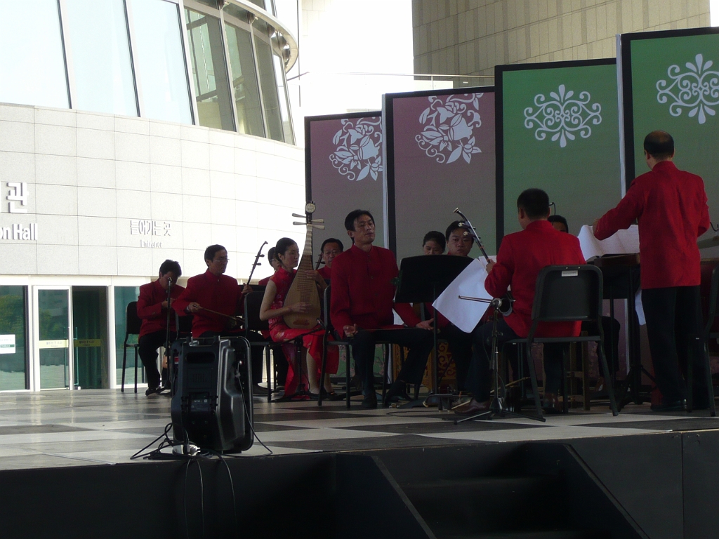 p1010886.jpg - After the DMZ tour, we went to the National Museum of Korea, where this ensemble was playing traditional Asian instruments outside the entrance.