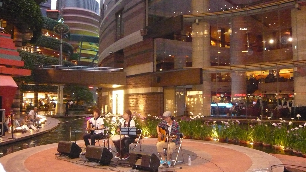 p1020576.jpg - A Japanese band, Misanga, playing in Canal City, Fukuoka.  Myra and I both really liked the song they were playing ("Believe in Myself").