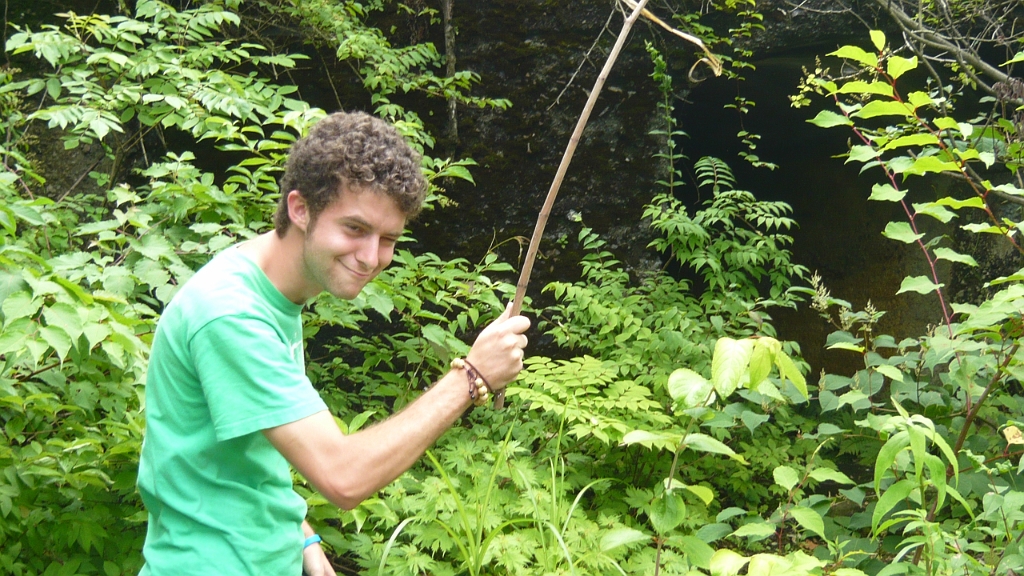 p1020710.jpg - Jeremiah brandishes a stick at some menacing spider webs.