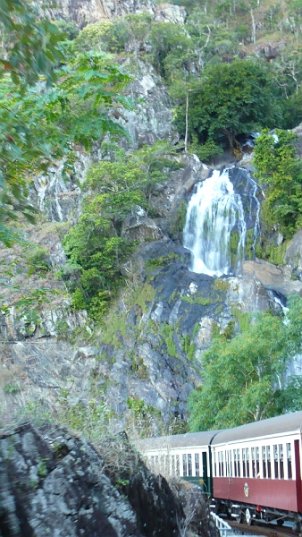 p1010145.jpg - The train takes a curve in front of another waterfall.