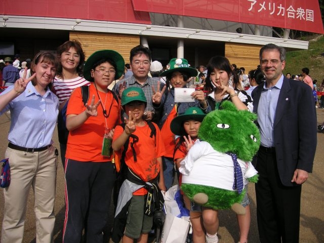 250000Visitor30Apr05.jpg - This family won our prize for being (well, one of them anyway) our 250,000th visitor.  This was in April, I think, about a month after the Expo opened.  The prize was that big Morizo plush, and maybe some other stuff too.  That's me with them, and one of the heads of our pavilion.