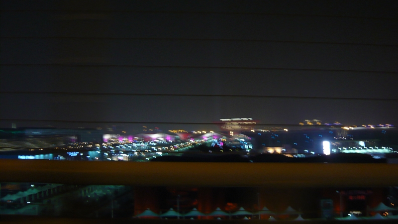 P1030133.JPG - On the taxi ride from Pu Dong Airport, I saw an illuminated expanse that looked like a fairground.  "Expo?" I asked the taxi driver. "Spo, spo!" he confirmed, pulling over into the right lane so I could get a better photo from the bridge we were crossing.