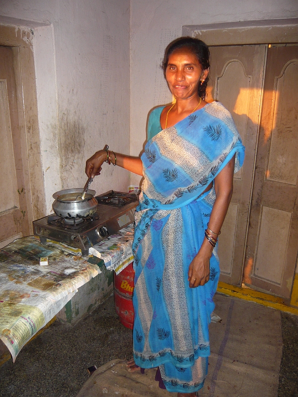 p1020150.jpg - Another of the women, in the kitchen.